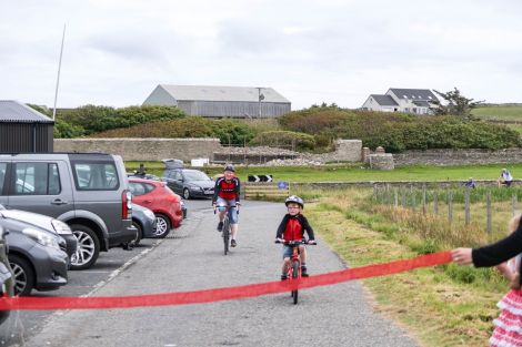 Ollie Jamieson nearing the finish line, pictured with his dad Steven. Photo: Tom Jamieson