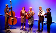 From left: bassist Graham Malcolmson, singers Sheila Duncan and Freda Leask, mandolinist Lewie Peterson and fiddler Lois Nicol around a single mic at Mareel on Saturday evening. Photo: Dale Smith