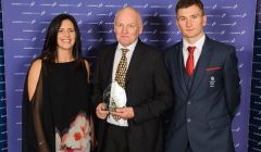 Paul Woods (centre) receives the impact club of the year award from Team GB track and field athlete Derek Hawkins, accompanied by Julie Mollison, Scottish Athletics National Club manager (north). Photo: Bobby Gavin.