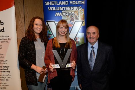 Kaylee Mouat and Lauren Smith from Shetland Junior Netball Development Group, with Alec Miller of Voluntary Action Shetland.