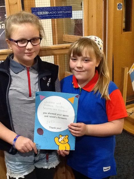 Rhiannon and Millie from the Whiteness and Weisdale Rainbows, Brownies and Guides, who raised £457 by hosting a coffee morning. Photo: BBC Radio Shetland.