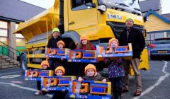 Councillors Steven Coutts (left) and Michael Stout (right) with the six pupils who chose the winning names for the gritters - Photo: SIC