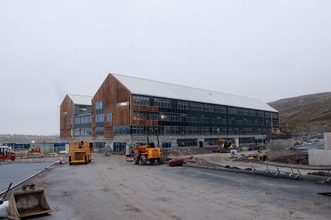 The school grounds are gradually emerging with the teachers' carpark on the right and the bus stop on the left .