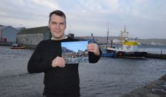 Fiddler Maurice Henderson proudly clutching a copy of his book In Search of Willafjord. Photo: Shetland News/Neil Riddell.