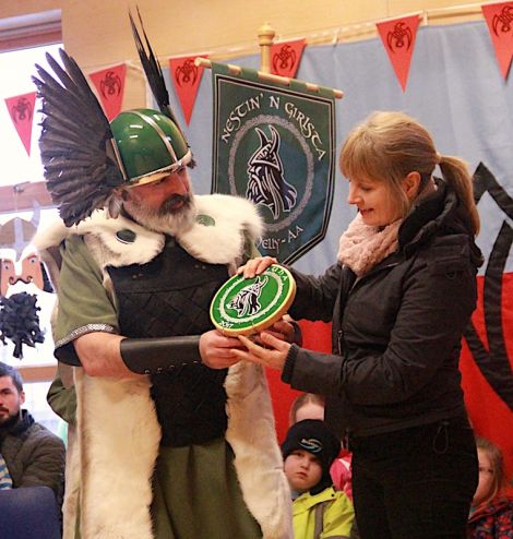 Teacher Vaila Stevenson accepts this year's Nesting & Girlsta Up helly Aa plaque on behalf of the school.