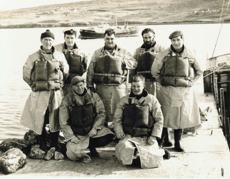 The Aith lifeboat crew in 1967. Back row (left to right): John Robert Nicolson (Coxswain), Frank Johnston (Mechanic), Kenny Henry (Crew), Michael Jamieson (Crew), Andy Smith (Bowman). Front row (left to right): Bill Anderson (Crew), Wilbert Clark (Assistant Mechanic) - Photo: Dennis Coutts