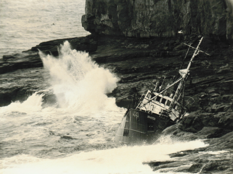 The trawler Juniper jammed against the rocks below 200 feet high cliffs at Papa Stour in 1967 - Photo: Dennis Coutts