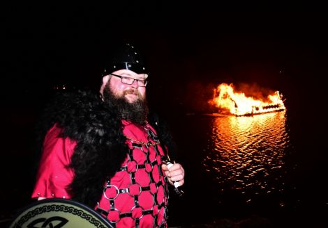 Northmavine guizer jarl Liam Doull witnesses his galley disappearing - Photo: Mark Berry