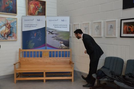 Yousaf inspecting the new bench, made by local firm Paparwark Furniture. Photo: Shetland News