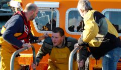 One of the Ocean Way fishermen being taken to safety at Lerwick Harbour on Friday morning - Photo: Chris Cope/Shetland News