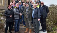 The SNP's Shetland branch convener Iain Malcolmson welcoming retiring SIC councillor Jonathan Wills into the fold outside Islesburgh on Saturday.