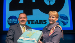 BBC Radio Shetland senior producer John Johnston and BBC Scotland director Donalda Mackinnon with the birthday cake. Photo: Malcolm Younger/Millgaet Media