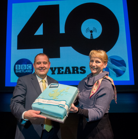 BBC Radio Shetland senior producer John Johnston and BBC Scotland director Donalda Mackinnon with the birthday cake. Photo: Malcolm Younger/Millgaet Media