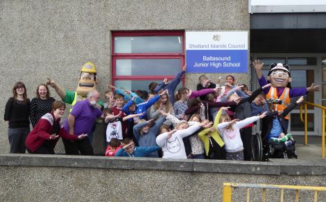 Ivor Goodsite and Honor Goodsite with pupils and staff at Baltasound Junior High School practicing Usian Bolt style celebrations. Photo: Morrison Construction