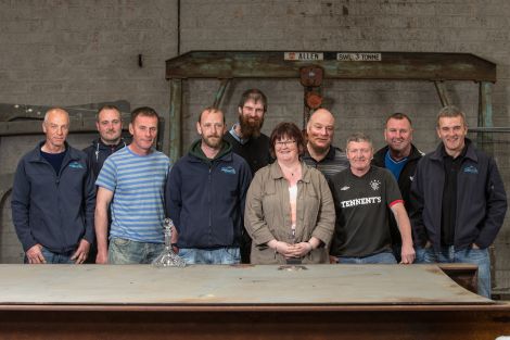 Cooke Aquaculture employees gather at the boat building yard to mark the occasion of the keel laying. From left to right: Tommy Ridland, Eric MacMillan, Ian Anderson, Jahn-Remi Hatledal, David Brown, Katrine Johnson, Dennis Johnson, John Wilson, Ewan Georgeson and Keith Leslie. Photos: Ivan Hawick