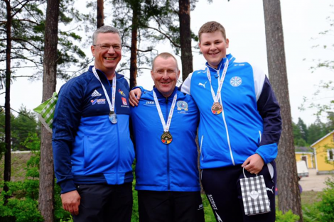 John Magnus Laurenson (centre) with his shooting peers after winning gold in the Olympic skeet individual event. Photo: Shetland Island Games Association