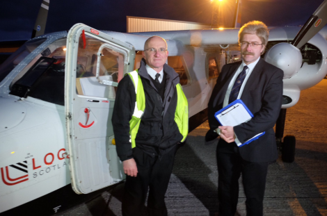 SIC returning officer Jan Riise (right) at Sumburgh Airport on Friday morning as a chartered plane was loaded with Shetland's ballot boxes. Photo: Shetland Islands Council