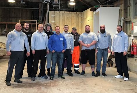 The strongmen in the now empty boat shed.