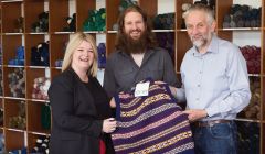 HIE account manager Kirsten Nicolson pictured with Garry and Peter Jamieson at Jamieson’s Spinning in Sandness. Photo: HIE/Ben Mullay.