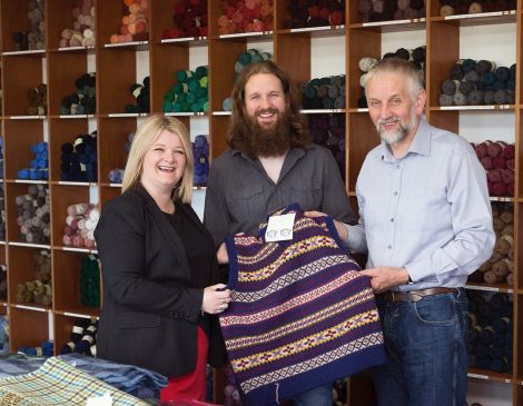 HIE account manager Kirsten Nicolson pictured with Garry and Peter Jamieson at Jamieson’s Spinning in Sandness. Photo: HIE/Ben Mullay.