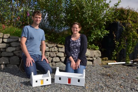 Luke and Kate Holt with two of their distinctive crofthouse planters in Quarff this week. Photo: Shetland News/Neil Riddell.