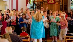 Veronica McBurnie leading participants in the "Big Sing" fundraiser at Da Big Kirk on Sunday night. Photo: Dale Smith.