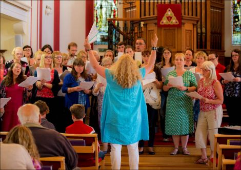 Veronica McBurnie leading participants in the "Big Sing" fundraiser at Da Big Kirk on Sunday night. Photo: Dale Smith.