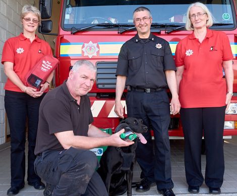 (L-R) Pheona Horne, Angus Mewdell, watch manager John Robertson and Tricia Brown with Teal the dog at the Yell fire station.