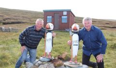 Charlie Priest (right) with his brother Bertie in front of their peat shed. Photo: Desley Stickle