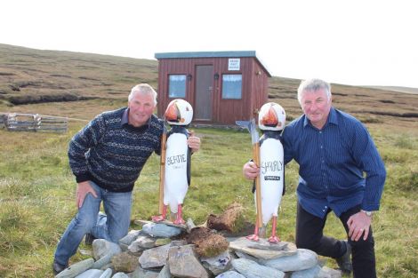 Charlie Priest (right) with his brother Bertie in front of their peat shed. Photo: Desley Stickle