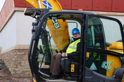 SRT chairman Bryan Leask trying out a digger. Photo: Chris Cope/Shetland News