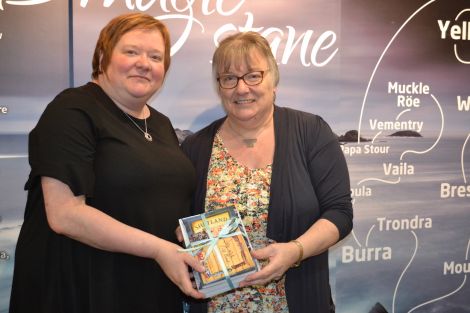 Liz and Margaret Tulloch presenting a collection of books plus CD from the late Lawrence Tulloch.