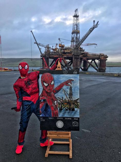 Spiderman safely on land with the painting in front of the Buchan Alpha platform. Photo: Kristof Onhausz