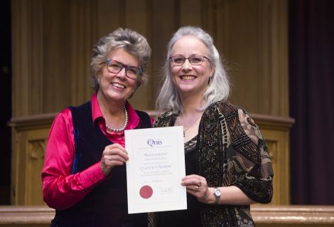 Clare Stiles (right) accepting her award from guest attendee Prue Leith, who is a judge on the Great British Bake Off. Photo: Lesley Martin Photography/QNIS