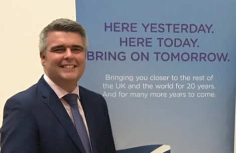 Flybe's Ronnie Matheson behind his company's tag line, which did not quite come to pass. Photo: Shetland News