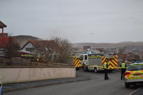 Sandyloch Drive was cordoned off while fire engines attempted to bring a house fire under control on Monday morning. Photo courtesy of BBC Radio Shetland.