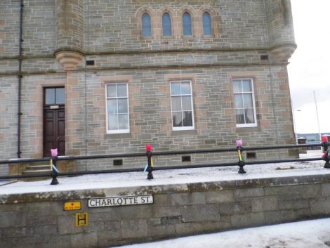 The crafted "pussy hats" were placed on the railings around Lerwick Town Hall in the small hours over the weekend. 