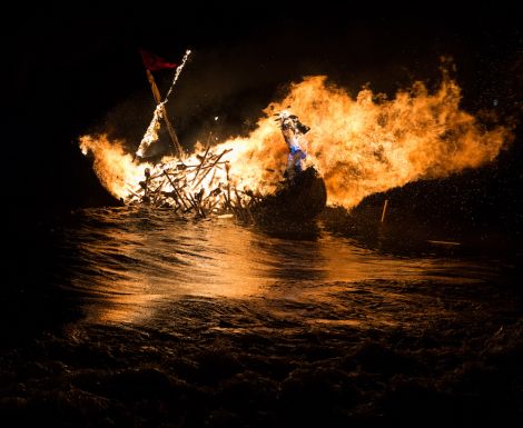 Waves are rolling on. The SMUHA galley burns as it floats out to sea.