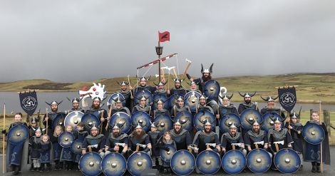 The jarl squad gathers for the traditional squad and galley photo outside Nesting school on Friday morning. Photo: Hans J Marter/Shetland News