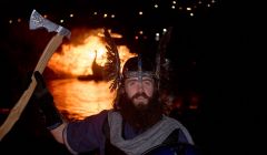 'An honour to represent the festival', Nesting & Girlsta guizer jarl with his burning galley on Friday night. Photo: Chris Brown