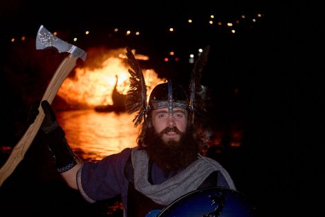 'An honour to represent the festival', Nesting & Girlsta guizer jarl with his burning galley on Friday night. Photo: Chris Brown