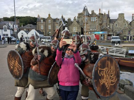 Vikings from Lerwick’s Jarl Squad create a lasting impression on passengers and crew from MV Columbus during her maiden call at Lerwick Harbour. Photo: Lerwick Port Authority. 