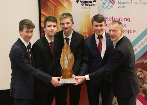 Left to Right: Shetland Gift Company members Scott Smith, Jack Irvine, Cameron Andrews, Michael Jamieson with local MSP Tavish Scott who presented the award. Photo: Stewart Hornal