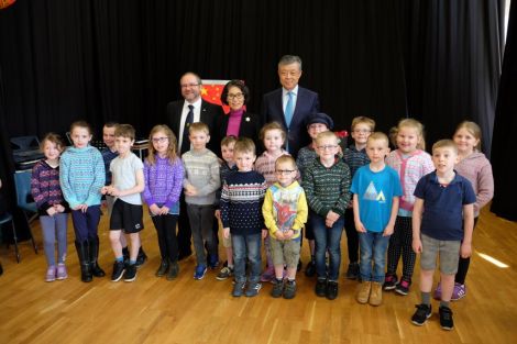 Primary pupils from Mid Yell JHS entertaining invited guests with a traditional Shetland song – Farewell to Yell. They are pictured with head teacher Mark Lawson (left), ambassador Liu Xiaoming and his wife Hu Pinghua. Photo: SIC