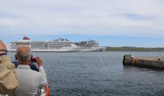 The Europa 2 leaving Lerwick Harbour at around 2pm on Tuesday while the much larger cruse ship MSC Meraviglia is still anchored in Bressay Sound. Photo: Hans J Marter/Shetland News