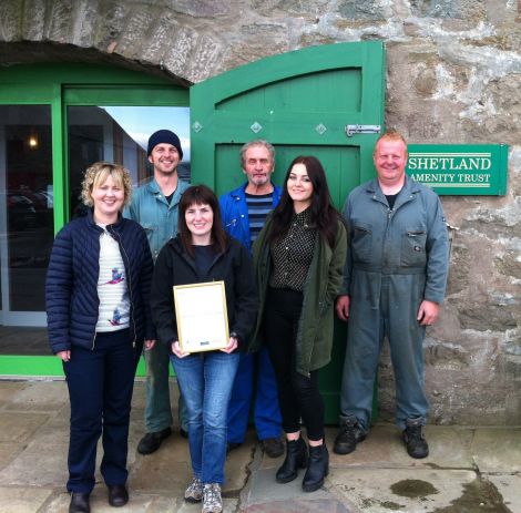 Sita Goudie with the award, flanked by Shetland Amenity Trust staff.