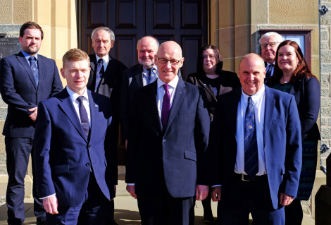 SIC top brass with John Swinney (front centre). Back row (L-R): Councillors Ryan Thomson, Allison Duncan, Alastair Cooper, Emma Macdonald and Theo Smith with chief executive Maggie Sandison. Front row (L-R): Convener Malcolm Bell, Swinney and councillor George Smith. Photo: SIC