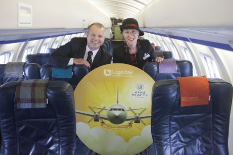 Managing director of Loganair Jonathan Hinkles and cabin crew member Sharon Williams showing off their gold award.