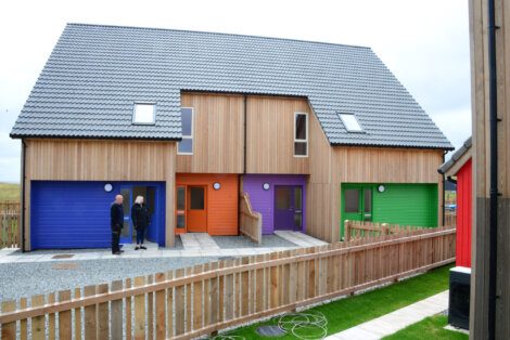 A wooden fence in front of a house.