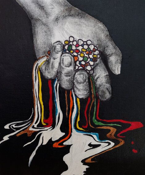 A grayscale hand holds colorful beads that appear to melt, creating multi-colored streaks flowing downwards on a black background.